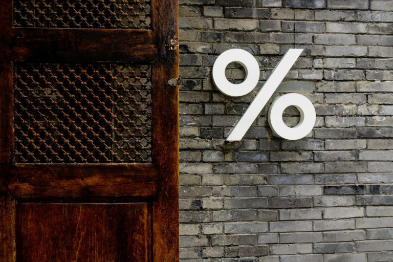 White percentage sign on a brick wall